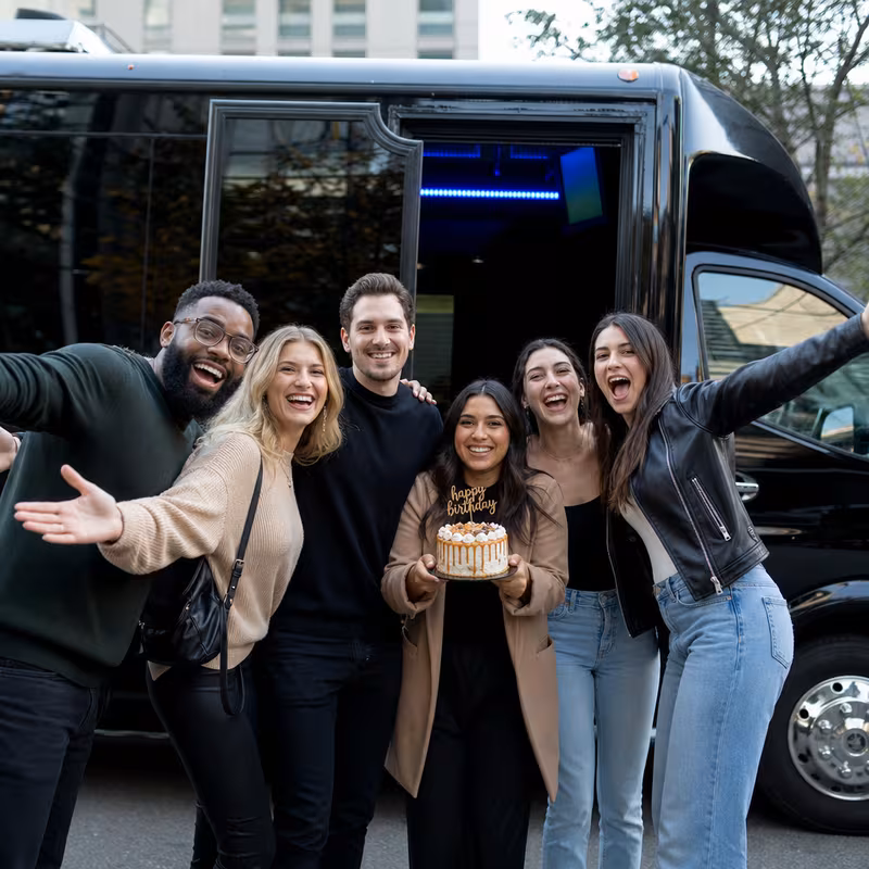 Group boarding a white charter bus for Birthday Transportation transportation in Scottsdale