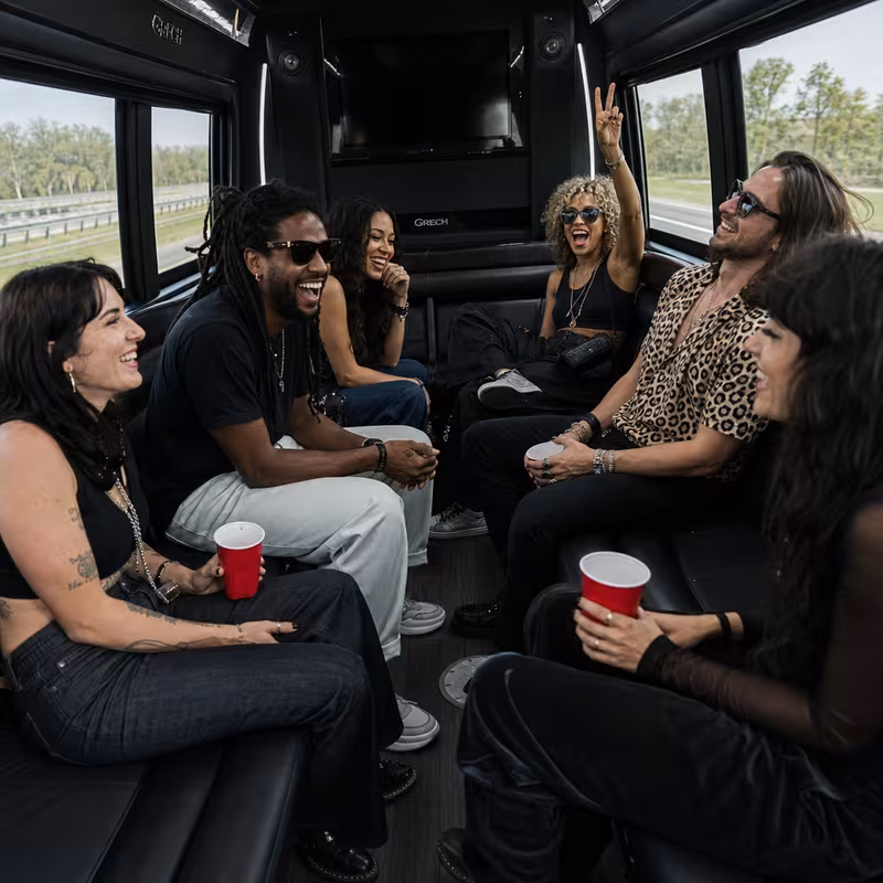 Group boarding a white charter bus for Concert Transportation transportation in Scottsdale