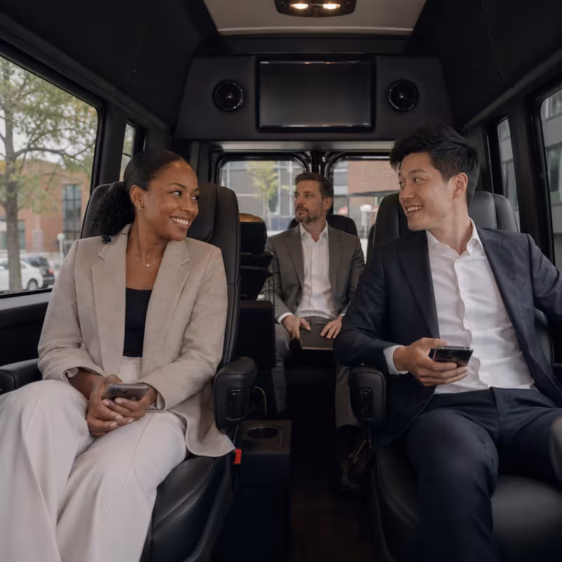 Group boarding a white charter bus for Corporate Transportation transportation in Scottsdale