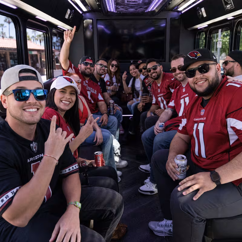 Group boarding a white charter bus for Sporting Event Transportation transportation in Scottsdale