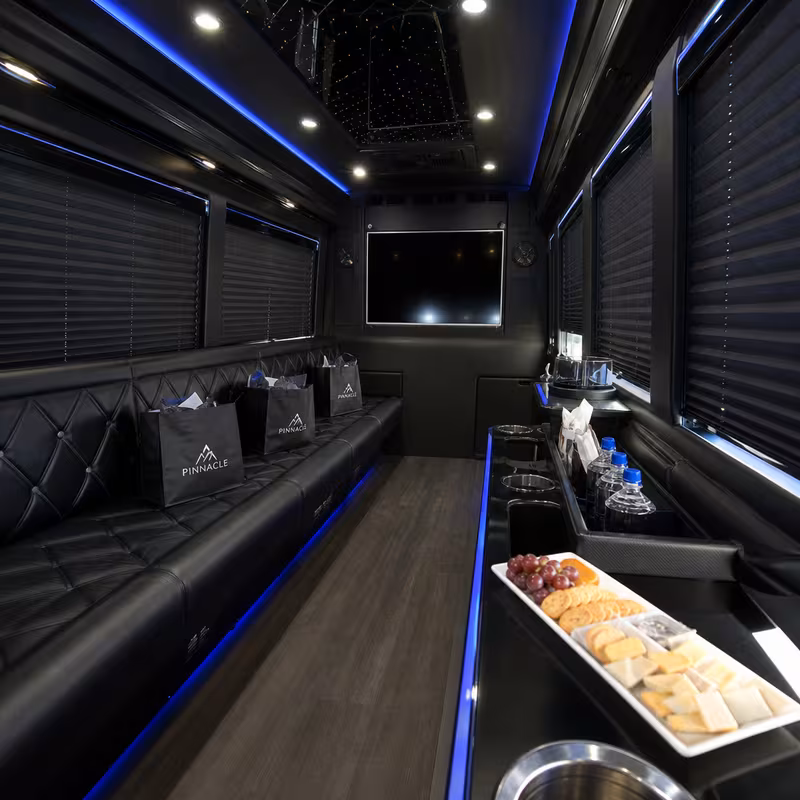 Party bus interior with wraparound leather seating and LED lighting in Scottsdale